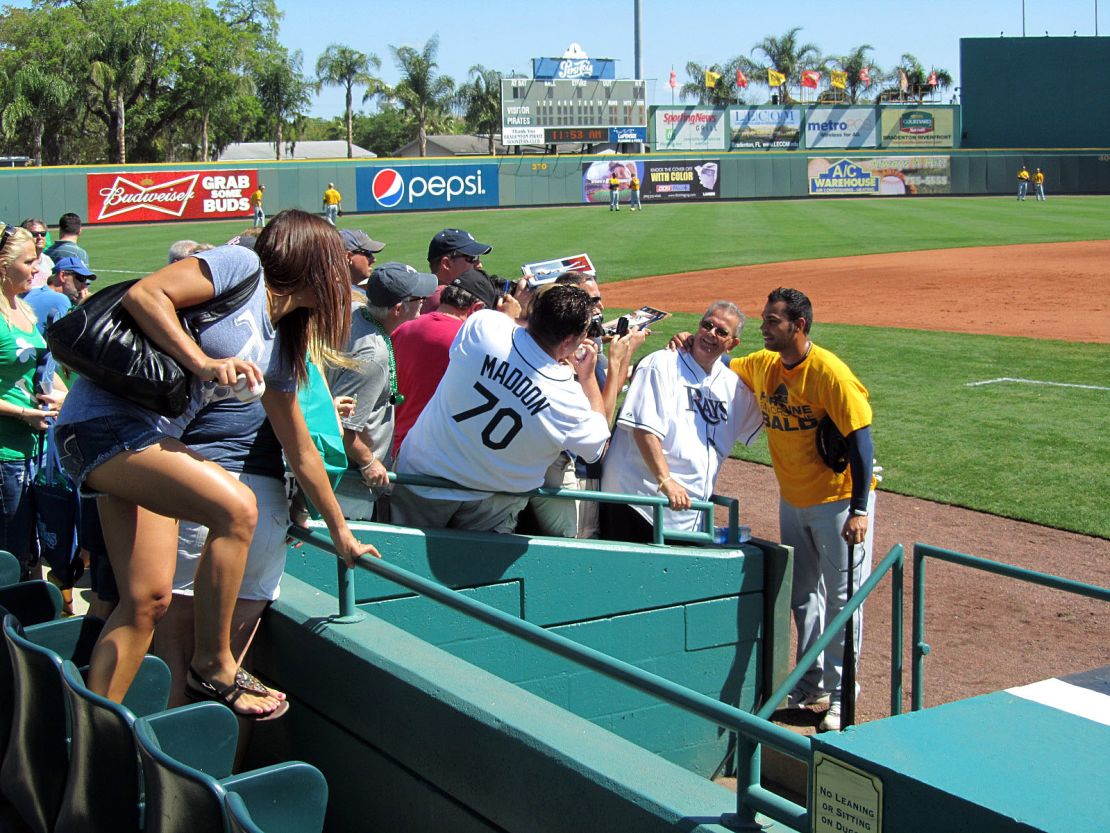 Tampa Bay Rays first baseman Carlos Peña poses with fans during spring training at McKechnie Field.