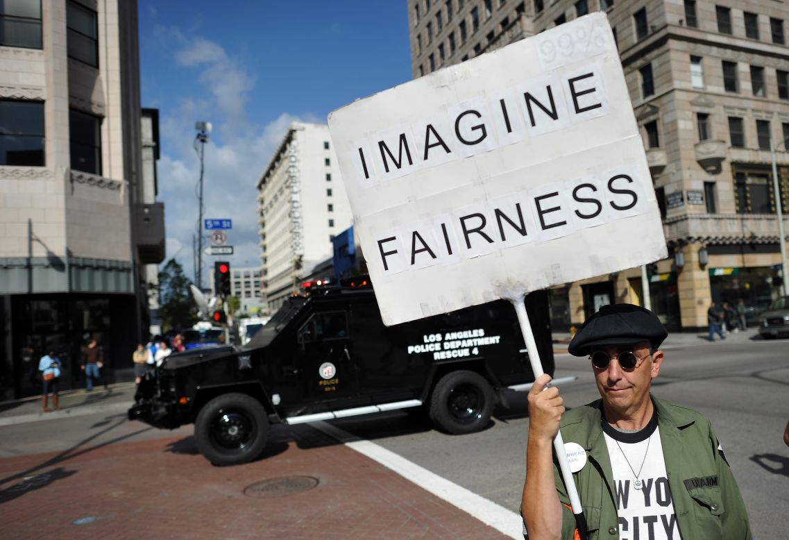 A man in downtown Las Angeles joins in protests held nationwide Monday in memory of the slain Florida teenager.