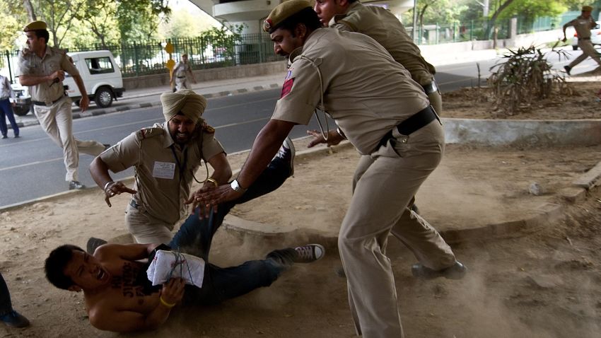 Police detain a Tibetan activist protesting outside the Oberoi Hotel in New Delhi on March 28, 2012.