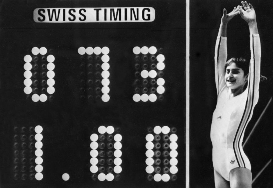 The Perfect 10: Nadia Comaneci celebrates next to the scoreboard after her uneven bars performance at the 1976 Montreal Olympics.
