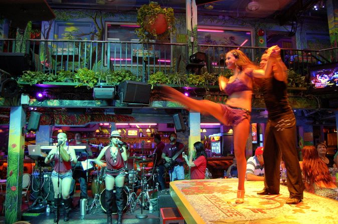 Mango's Tropical Cafe hosts a bartop dance show in South Beach.