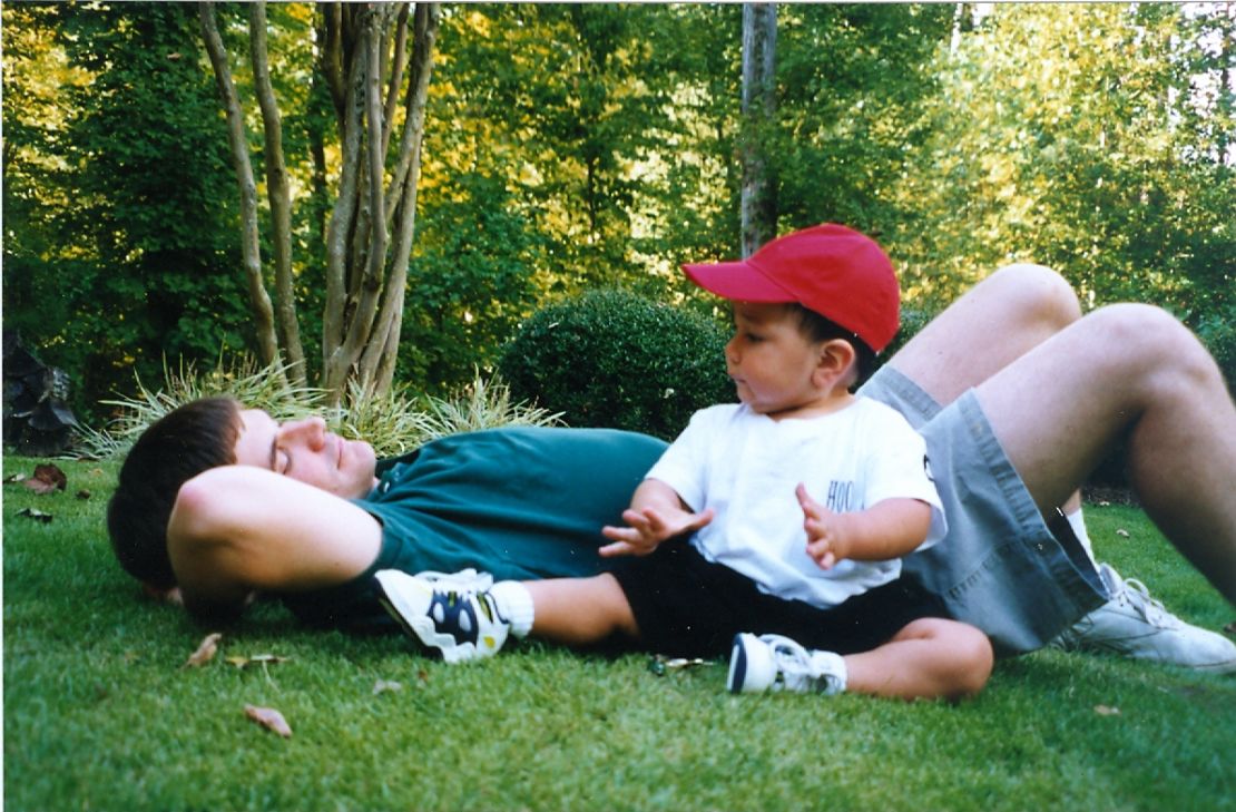 Frankie Sanders at age 15 months relaxes with his father Charlie Bailey.