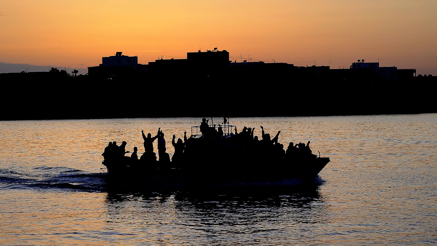 A boat carrying Tunisian migrants enters the port of Lampedusa on April 12, 2011 The island is close to North Africa. 