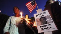 Supporters gather during a candelight vigil at a memorial to Trayvon Martin outside The Retreat at Twin Lakes community where Trayvon was shot and killed .