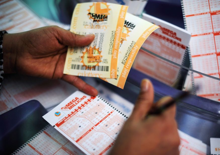  A woman fills out a Mega Millions ticket form at Liquorland in Covina, California.
