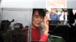 Myanmar opposition leader Aung San Suu Kyi waves to supporters after she visited a polling station in Kawhmu where she stands as a candidate in parliamentary by-elections on April 1, 2012.