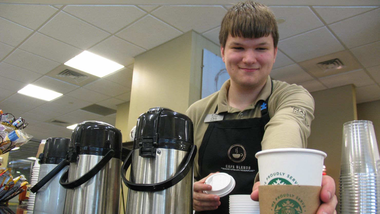 Chris Pavlak stands behind the coffee bar at Cafe Blends.  The cafe is staffed by young adults on the autism spectrum.