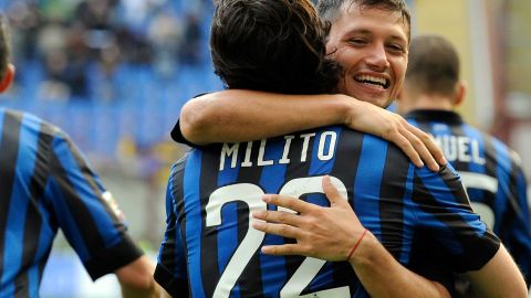 Diego Milito is congratulated by Mauro Zarate after completing his hat-trick against Genoa in the San Siro.