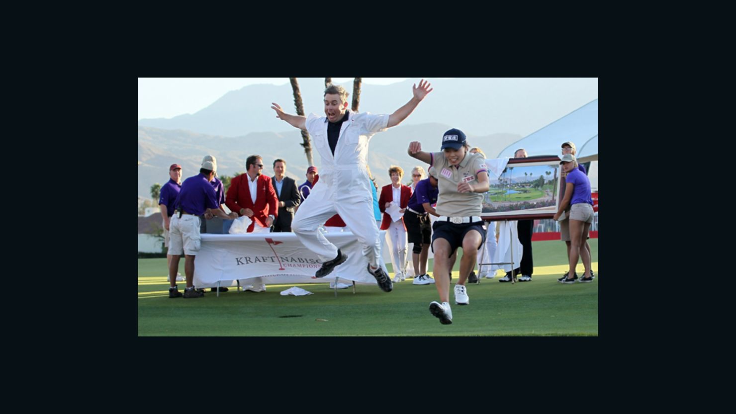 Sun Young Yoo and caddy Adam Woodward take the traditional leap into Poppie's Pond after the Korean won in a playoff