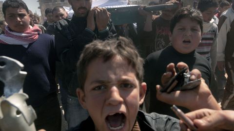 Syrians carry the coffin of a 13-year-old boy who was allegedly killed by regime troops in Sermin in late March.