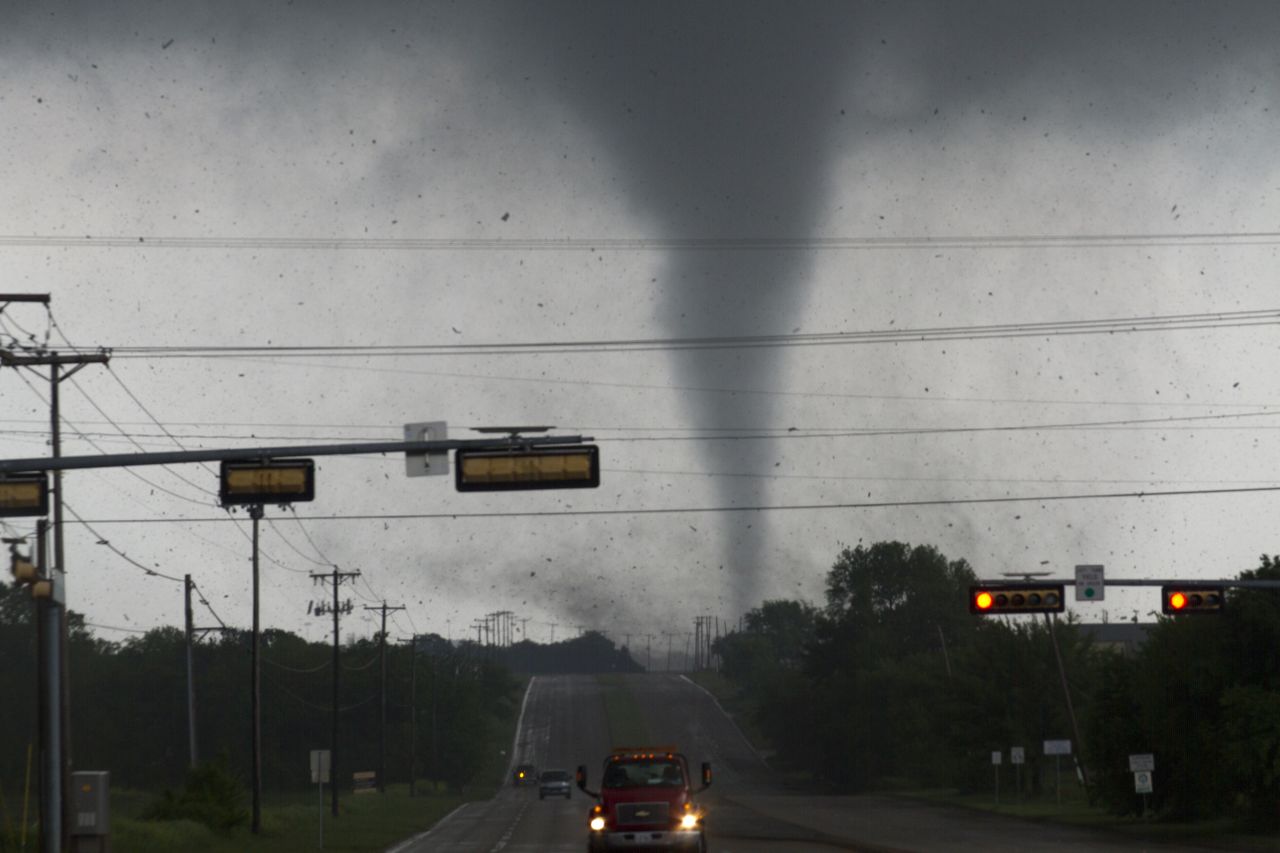 A tornado touches down in Lancaster, Texas, on Tuesday. Multiple tornadoes ripped through the Dallas-Fort Worth area, causing extensive damage.
