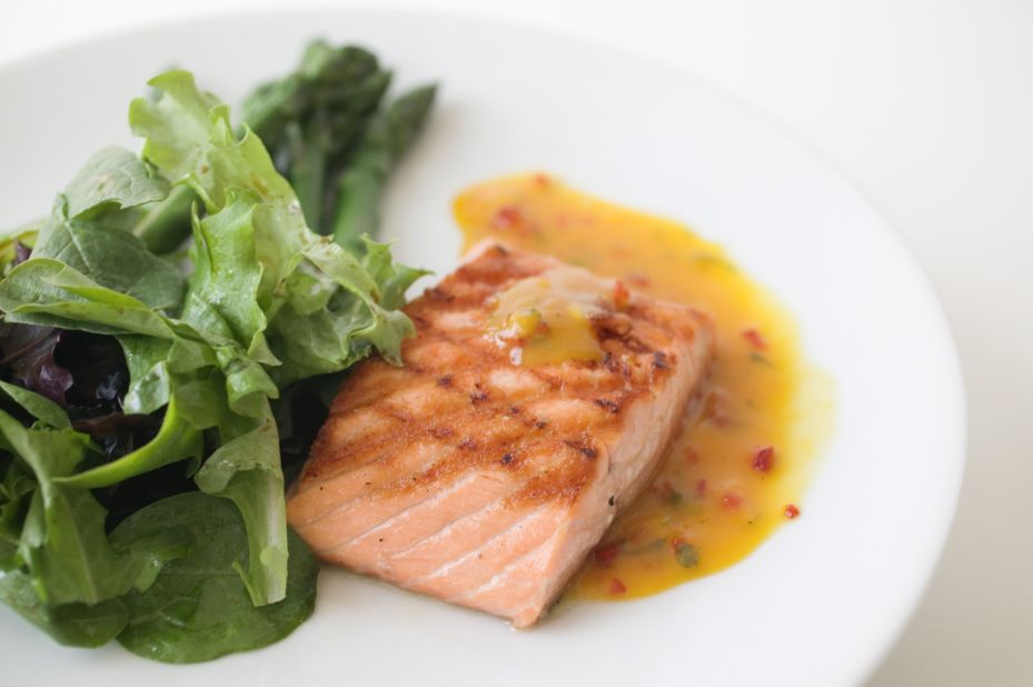 "Fatty fish, such as salmon and tuna, contain omega-3 fatty acids, which help control inflammation in your body," dietitian Maxine Yeung says.