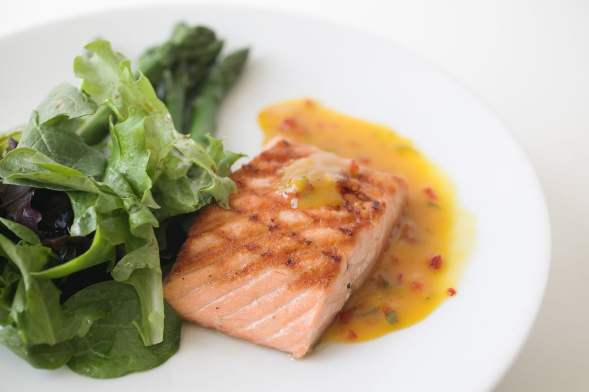 "Fatty fish, such as salmon and tuna, contain omega-3 fatty acids, which help control inflammation in your body," dietitian Maxine Yeung says.