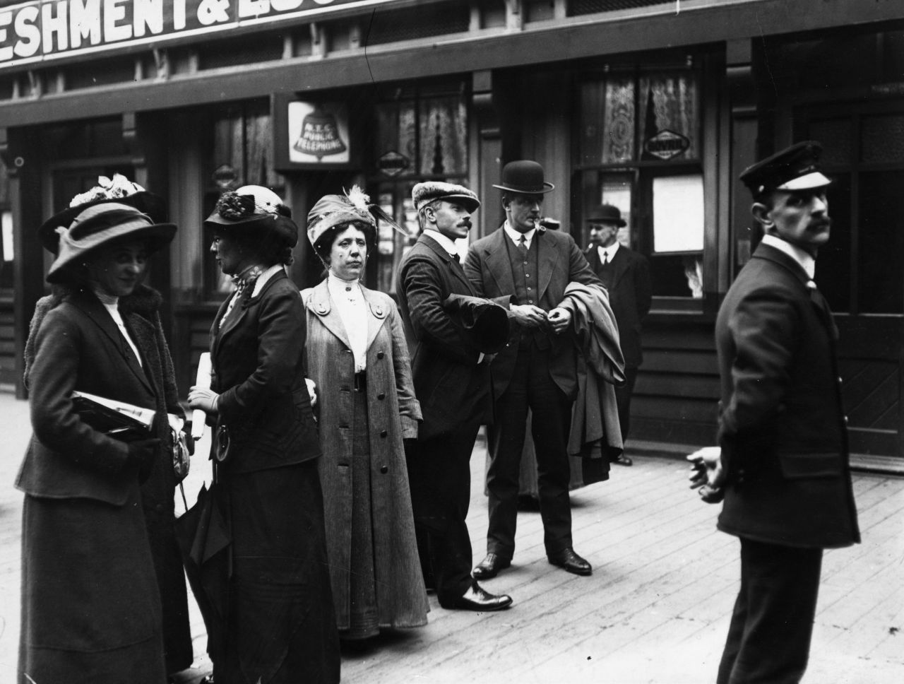 Survivors of the Titanic catastrophe arrive in Liverpool, England, in May 1912. Third Officer William Pitman, in the cap, stands on the right.