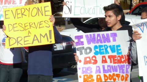 Young Latino protesters hold placards outside Mitt Romney' s Nevada campaign headquarters in Las Vegas in February