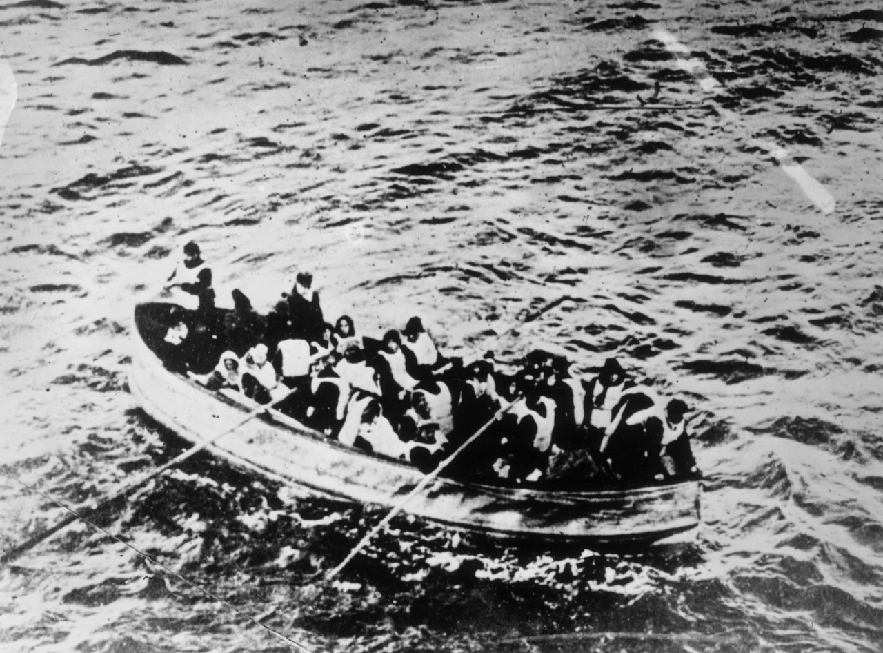 The ship struck an iceberg near midnight on April 14, 1912 and sank into the Atlantic Ocean a little less than four hours later. Survivors of the Titanic disaster crowded into lifeboats.