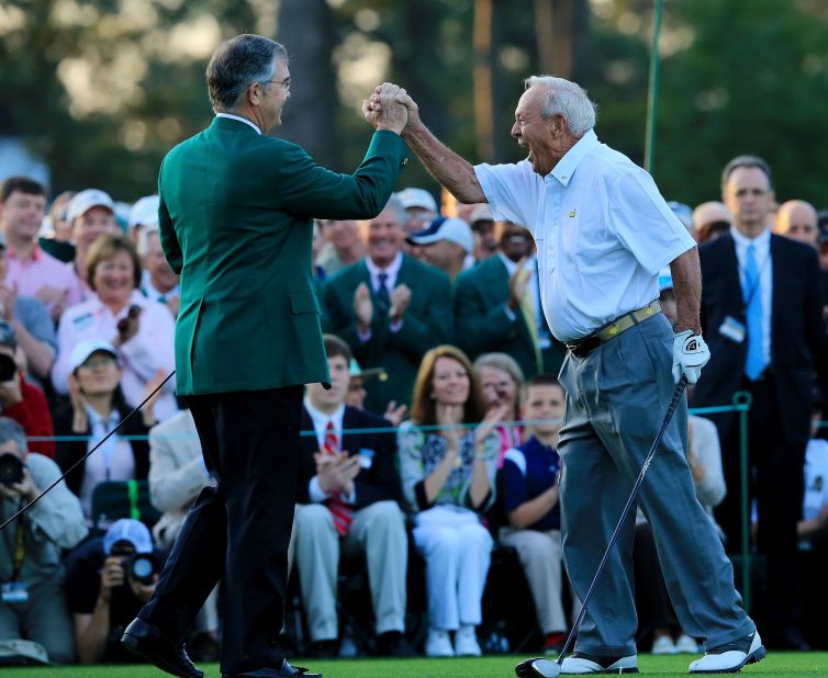 Arnold Palmer, right, celebrates with Augusta National president Billy Payne after launching the 2012 Masters with a ceremonial tee shot 50 years after his "Annus Mirabilis." Palmer was joined by fellow golf legends Jack Nicklaus and Gary Player in making the honorary drives down the fairway.