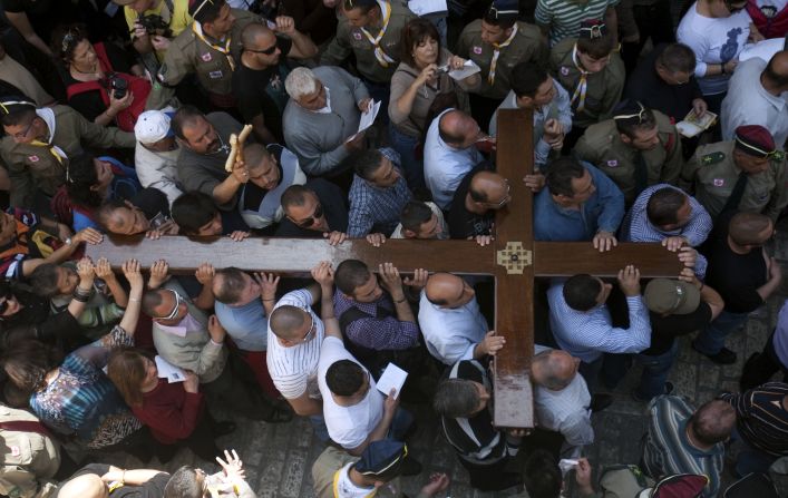 Christian Arab worshipers carry a large wooden cross along the Via Dolorosa, or the Way of Suffering, as they enter the Church of the Holy Sepulchre, an ancient, sprawling shrine that Orthodox and Catholic Christians believe was built on the original site of the crucifixion.