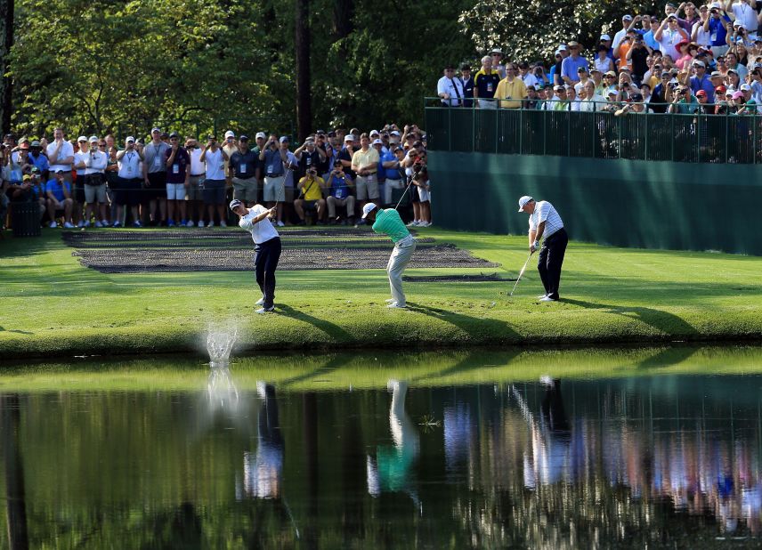 Sean O'Hair, Woods and Mark O'Meara skip their balls over the water during a practice round earlier in the week at  Augusta National Golf Club.