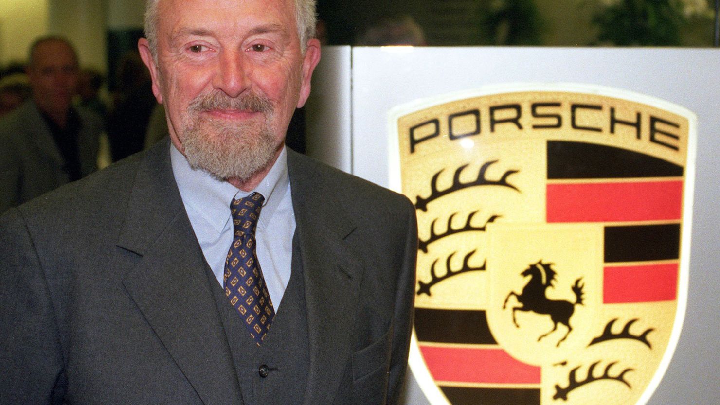 Picture from January 22, 1999 shows Ferdinand Alexander Porsche next to the logo of German car maker Porsche in Stuttgart.