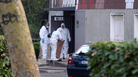 Members of the forensic service of the French police work near where a 47-year-old woman was shot in the head on April 5.