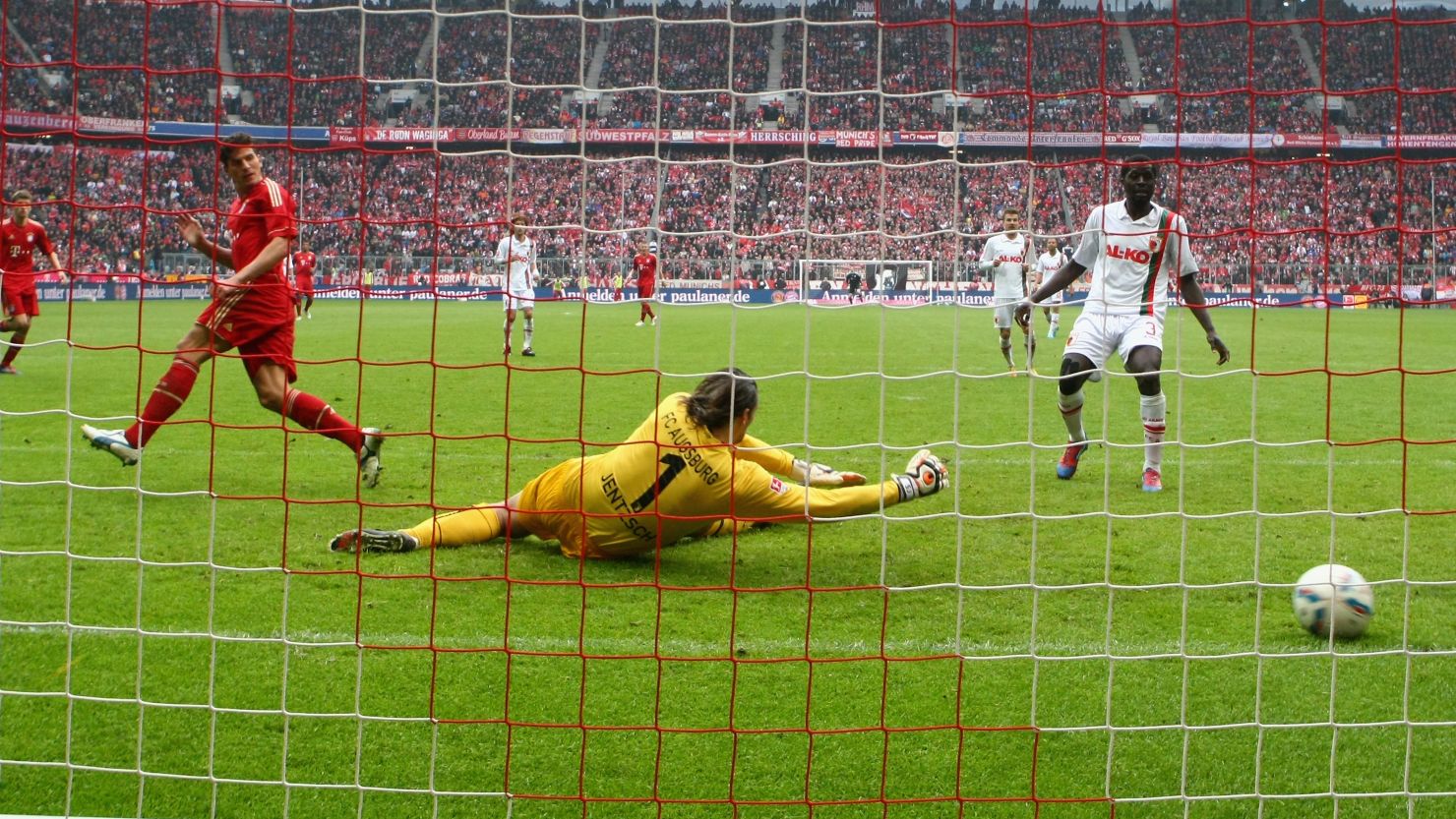 Mario Gomez (left) slots home his second goal in the 2-1 win over Augsburg in the Bundesliga on Saturday 