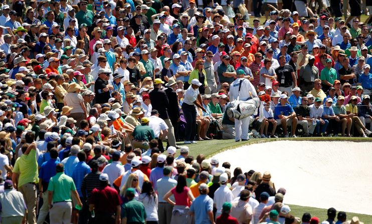 Tiger Woods is surrounded by patrons as he chips onto the ninth green on Saturday. The world No.7 finished the day with a even-par round of 72 to leave him three-over for the tournament and well off the pace.  
