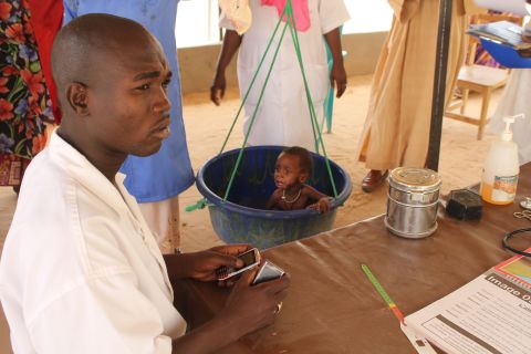 A child is weighed in at a nutritional feeding center in Mao, Chad. UNICEF estimates that more than a million children are at risk across the Sahel.