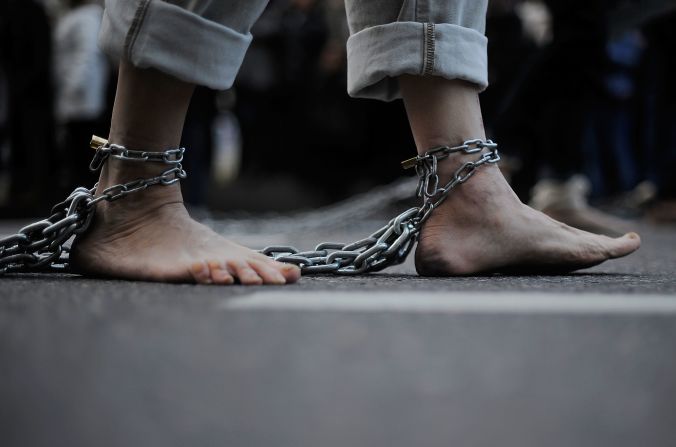 A penitent of the Jesus Nazareno de Medinaceli brotherhood drags chains along the ground during the Holy Week procession Friday in Madrid, Spain. Many regions throughout Spain celebrate Easter week with religious processions.