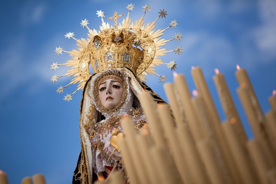 The Nuestra Senora de los Dolores Coronada, of the Dolores brotherhood, heads down a street during a Holy Week procession Friday in Cordoba, Spain.