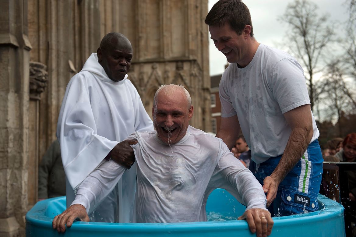 Archbishop of York John Sentamu, left, baptizes a local churchgoer during an Easter ceremony Saturday in York, England. The baptism of adults by total immersion is a ritual signifying the death of a believer's old life and a rebirth in Christ. Easter Sunday celebrates the resurrection of Jesus three days after his execution on the cross.