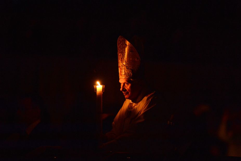 Pope Benedict XVI holds a candle during the Easter Vigil on Holy Saturday at St Peter's Basilica at the Vatican.