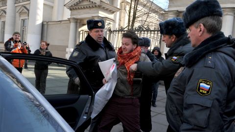 Police officers detain a gay rights activist who tried to protest against local anti-gay legislation in St. Petersburg on April 5, 2012.