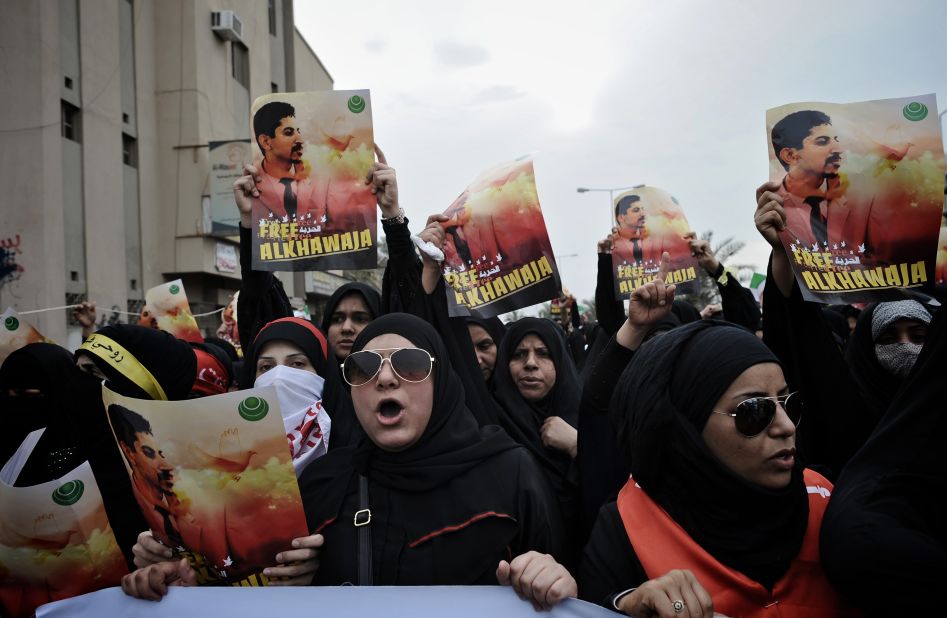 Bahraini Shiite demonstrators hold posters of jailed activist Abdulhadi al-Khawaja during a protest calling for his release in the village of Jidhafs, west of Manama, on April 6, 2012. 