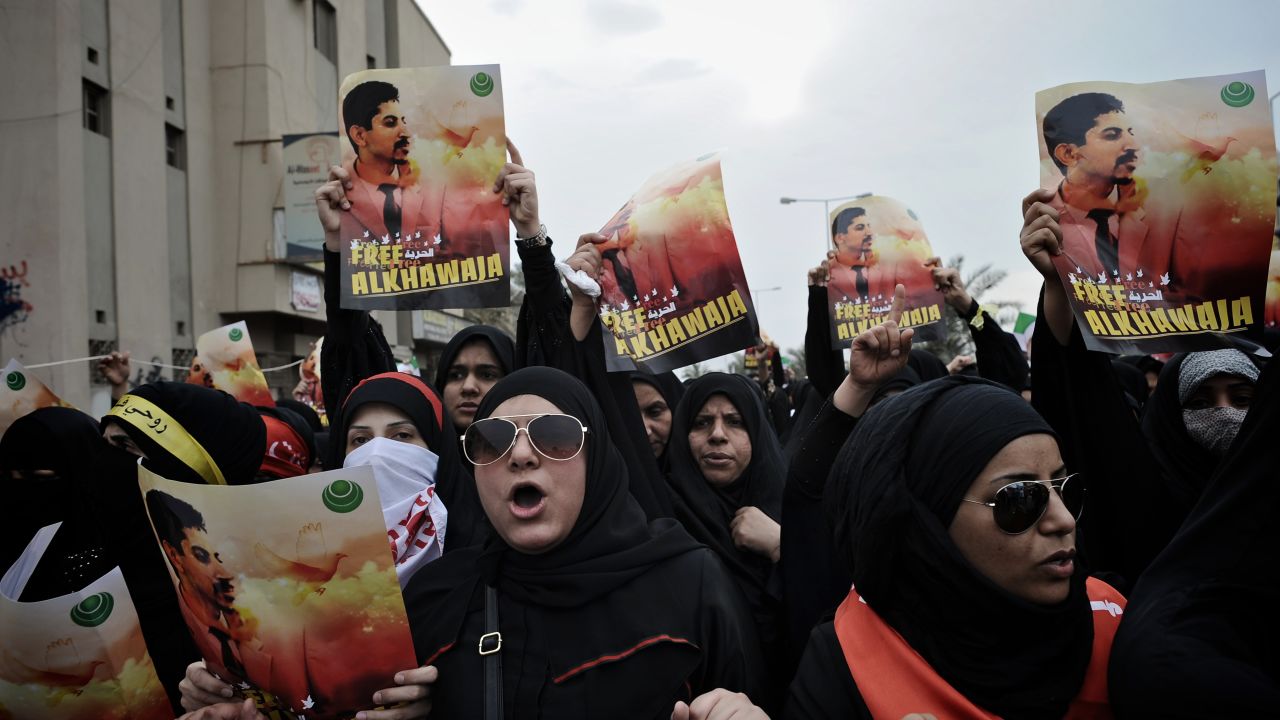Bahraini Shiite demonstrators hold posters of jailed activist Abdulhadi al-Khawaja during a protest Friday. 