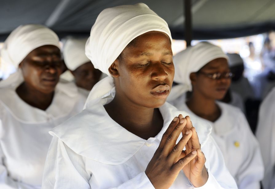 Women pray and sing at an Easter Sunday service at an outdoor church in Lilongwe, Malawi. 