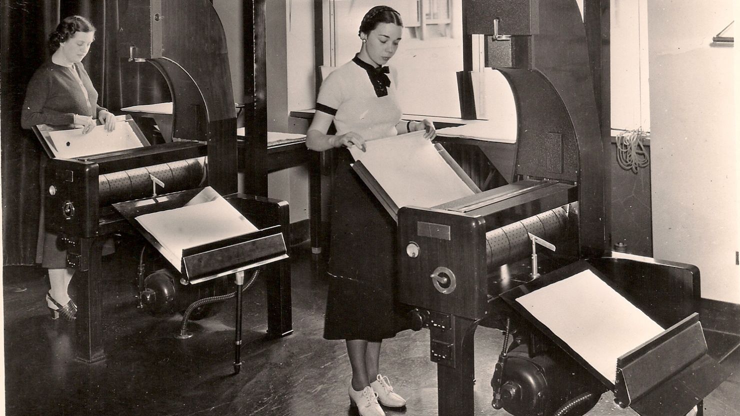 Census Bureau employees process microfilm records, circa 1940. Online records mean no more traveling to microfilm archives.