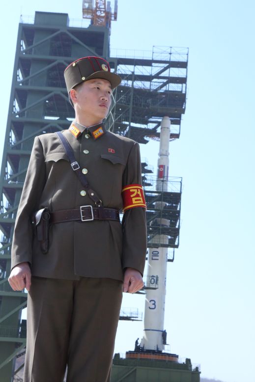 A North Korean soldier stands guard in front of the Unha-3 rocket during a media tour of the Sohae Satellite Launching Station on April 8, 2012.