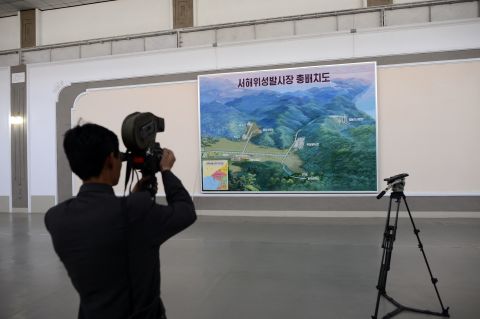 A North Korean cameraman films a map showing the site where the Unah-3 rocket is being prepared for launch.