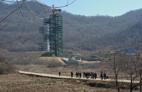 North Korean officials and foreign journalists leave the launch pad after a visit to see the rocket Unha-3 at the space center on April 8.