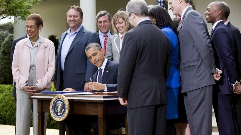  President Barack Obama, surrounded by lawmakers and business leaders, signs the JOBS Act last week in the Rose Garden.