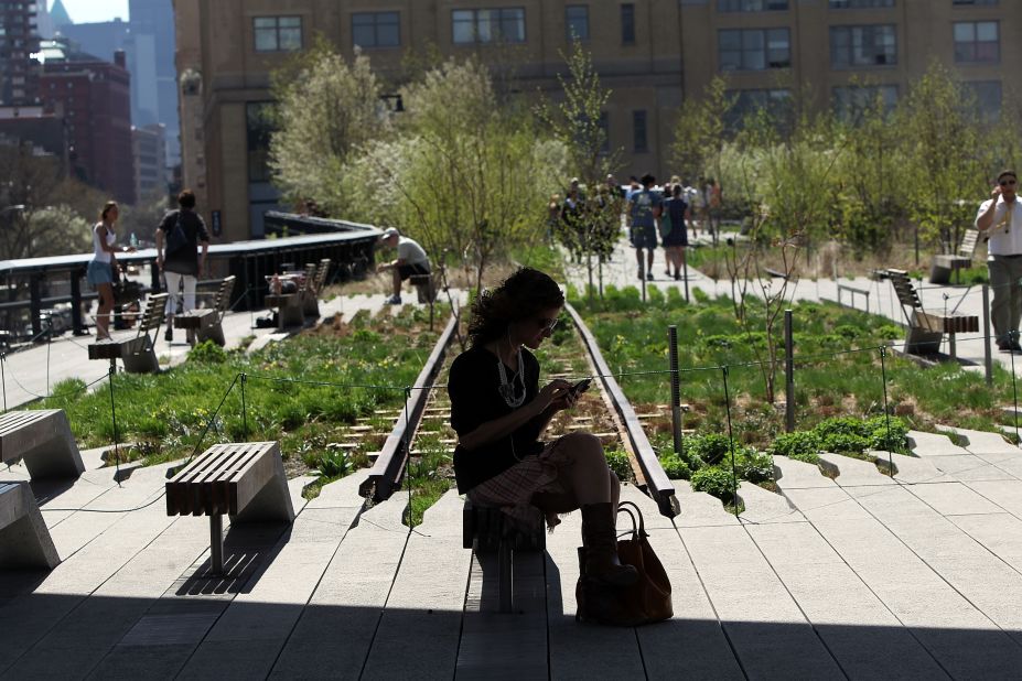 People take in the warm weather at the High Line, Manhattan's newest park constructed on a former elevated railroad track.
