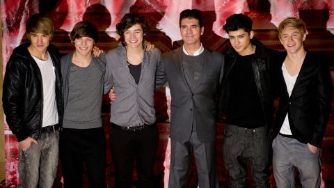 Simon Cowell (center) shown here with One Direction in 2010.