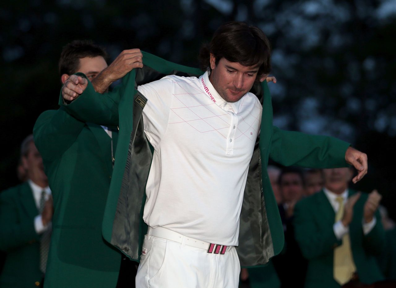 Bubba Watson receives the green jacket from 2011 winner Charl Schwartzel of South Africa.