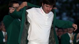Bubba Watson receives the green jacket from 2011 winner Charl Schwartzel of South Africa.