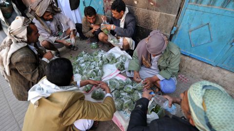 A Yemeni vendor displays qat leaves, a popular mild narcotic plant, for sale at an outdoor market in Sanaa.