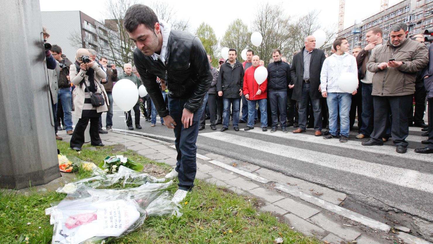 People lay flowers at the site in Brussels, Belgium where a transport worker was beaten to death on April 7.