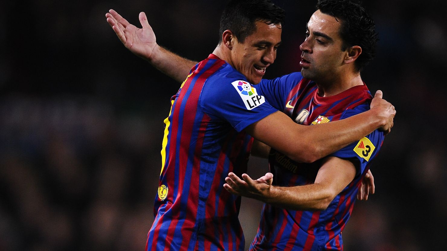 Alexis Sanchez of Barcelona celebrates with his teammate Xavi Hernandez after scoring the opener in the Nou Camp.
