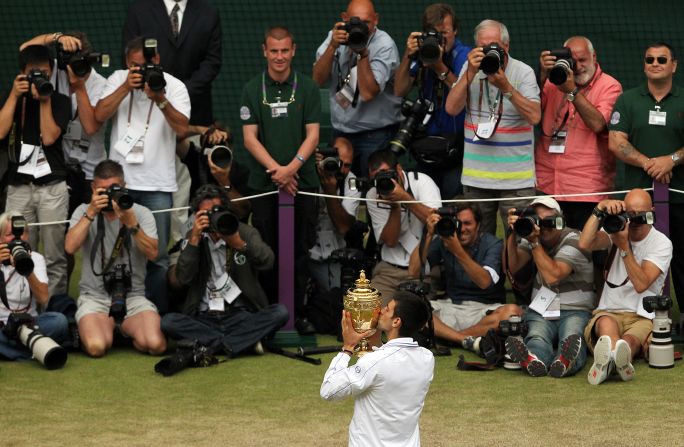 Djokovic plays up to the cameras after winning his first Wimbledon in 2011, beating Nadal 6-4 6-1 1-6 6-3 in a final lasting two hours, 28 minutes.