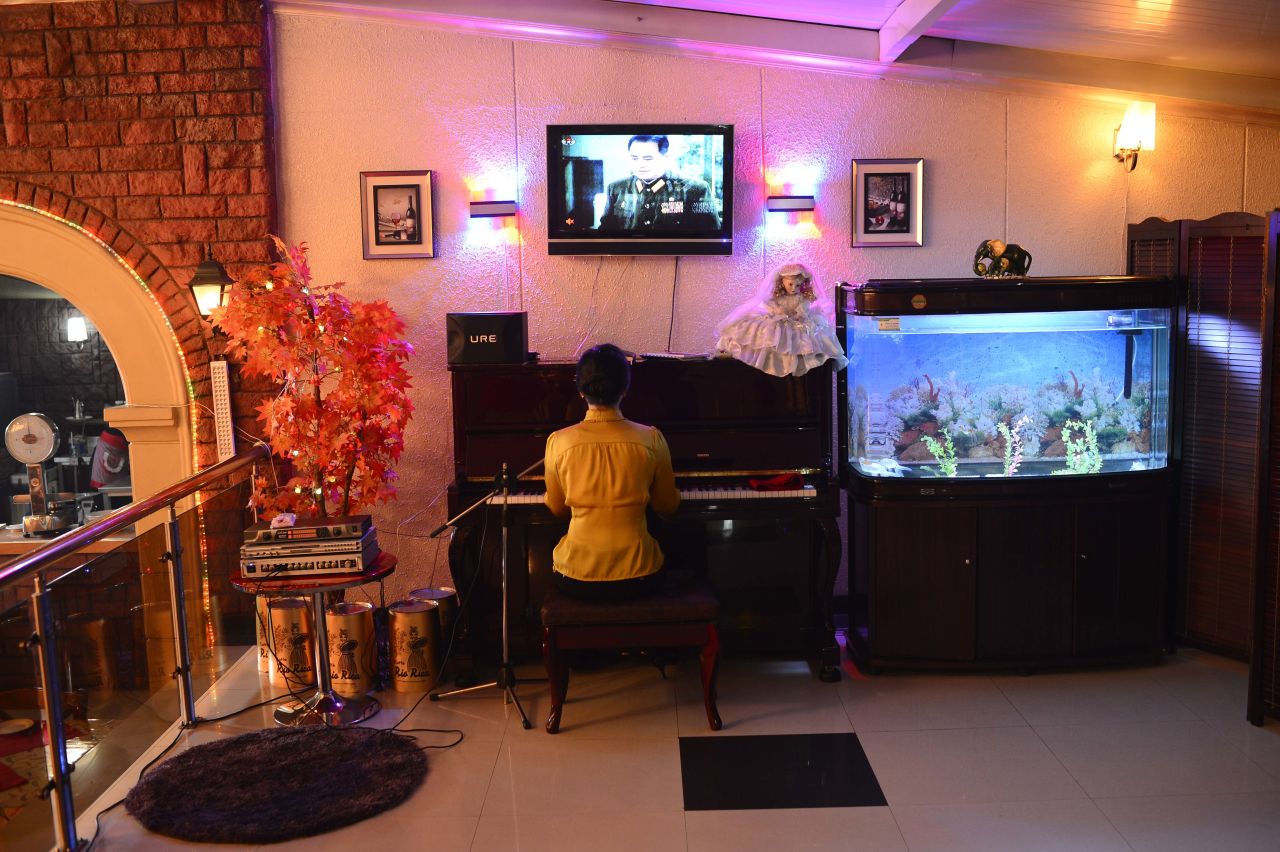 A woman plays the piano and entertains in a downtown Pyongyang restaurant. U.S. President Obama said the real consequence for North Korea, should it go through with the launch, is that the country's leaders will miss an opportunity. "I hope that at some point the North Koreans make the decision that it is in their interests to figure out how to feed their people and improve their economy rather than have big parades where they show off weapons," he said in March.